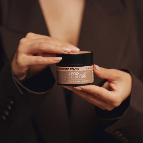 Palu żel budujący pro light builder gel "Gold Beige Cover" 45g. Dłonie trzymające żel z przedłużonymi paznokciami o delikatnym beżowym odcieniu.